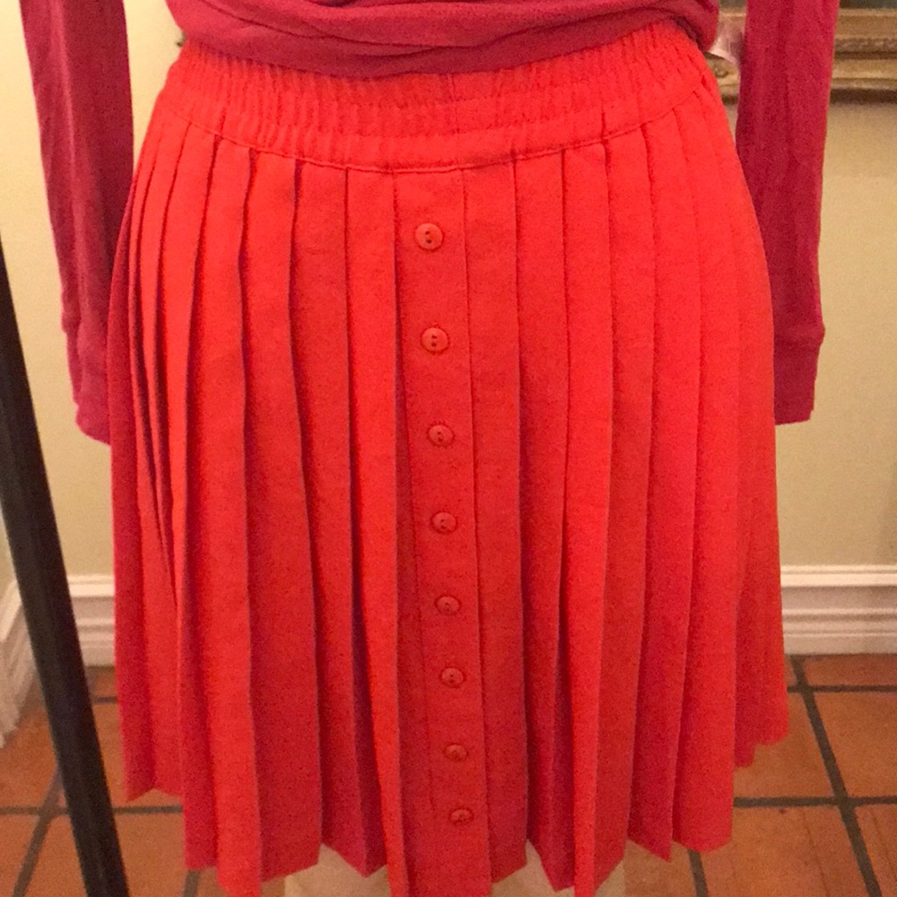 Pink top and red pled skirt
